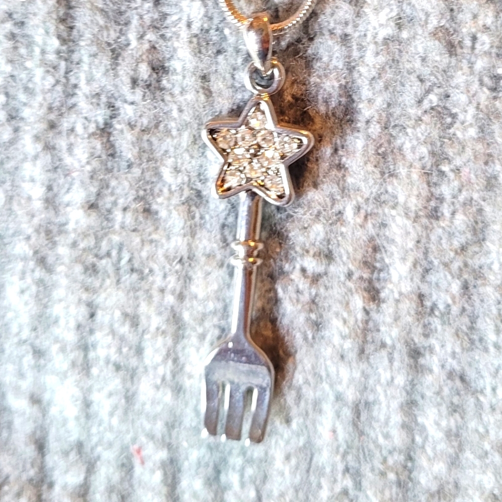 Silver necklace with star on a fork